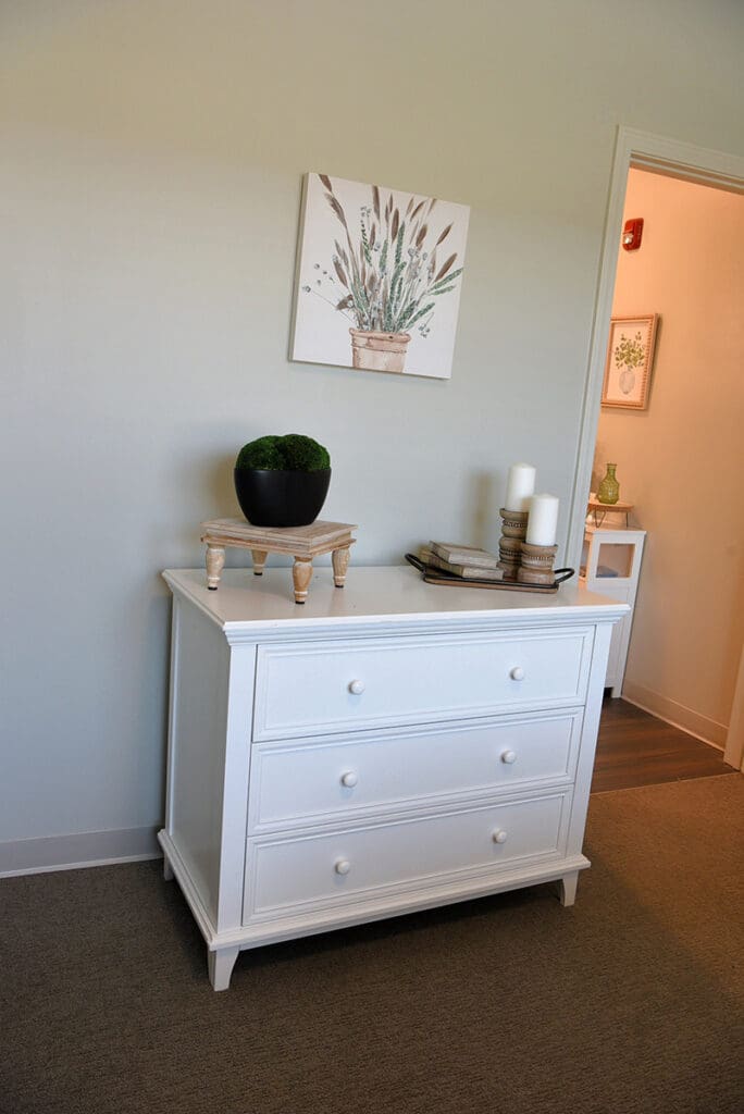 dresser with decor and artwork