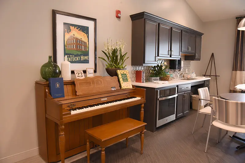 common area with kitchenette and piano