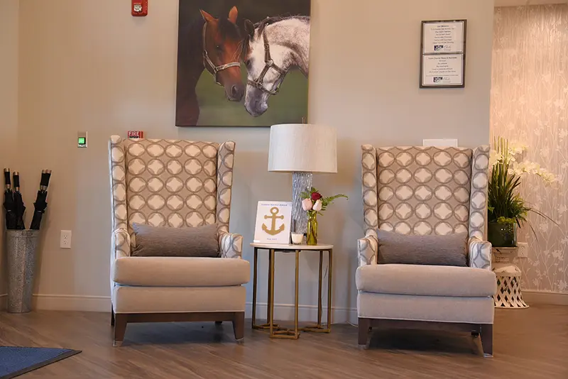 seating area with captain chairs and artwork