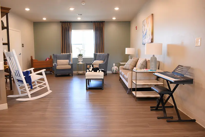 living room with rocking chair and keyboard