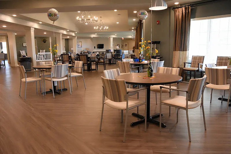 large community room with dining tables and seating