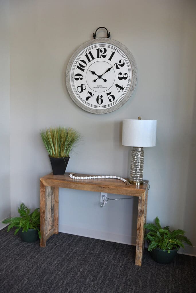hall table with lamp and hanging clock
