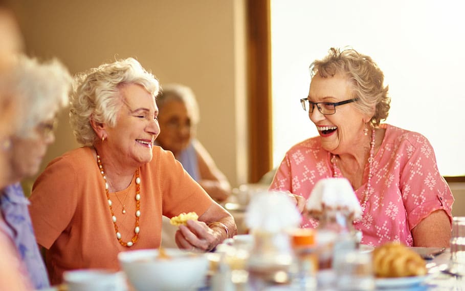 Seniors sharing a joyful meal at Charter Senior Living of Hopkinsville in KY.