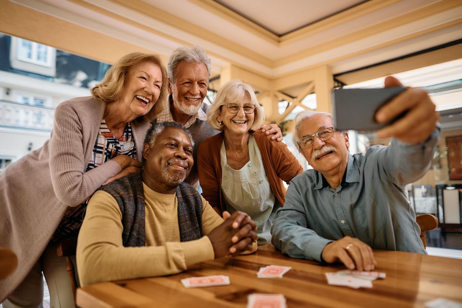 Residents laughing and taking a selfie during a card game at Charter Senior Living of Hopkinsville in Hopkinsville, KY.